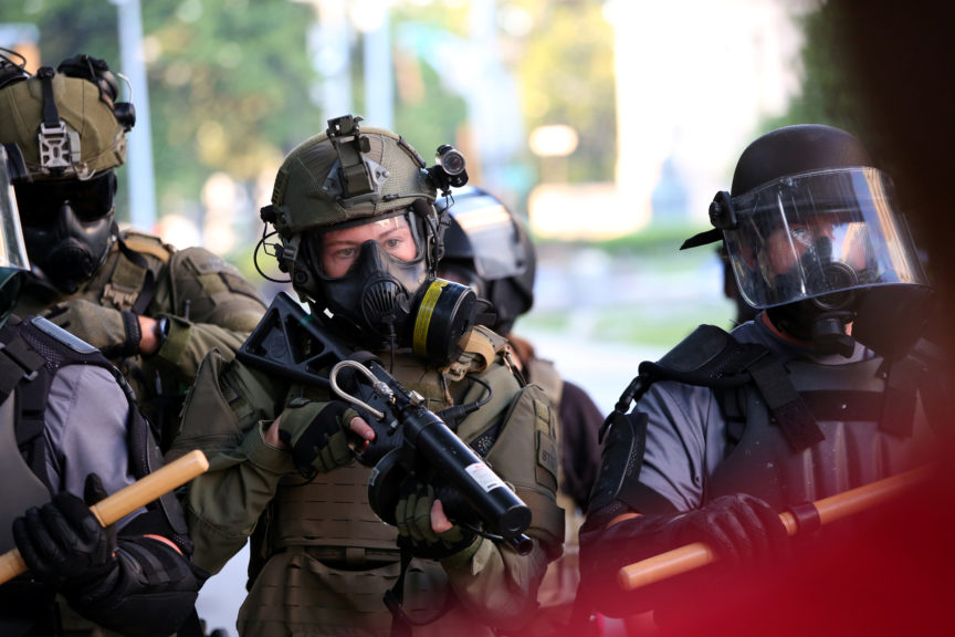 A police officer with a rubber bullet gun in Minneapolis