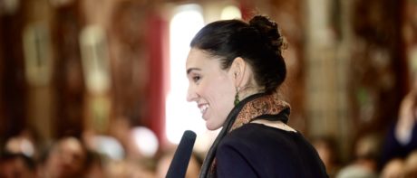 Jacinda Ardern smiling at a microphone