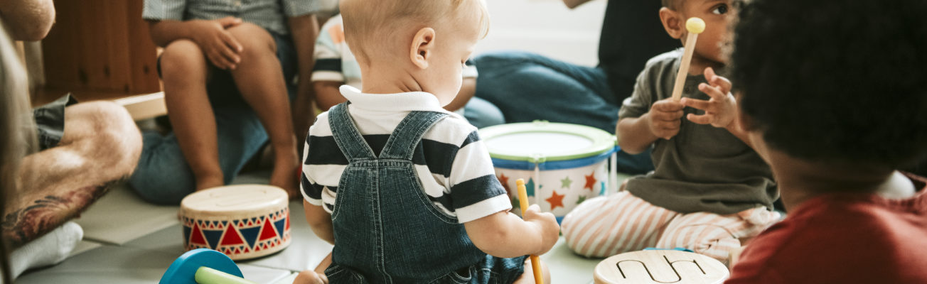 nursery children and teachers playing together
