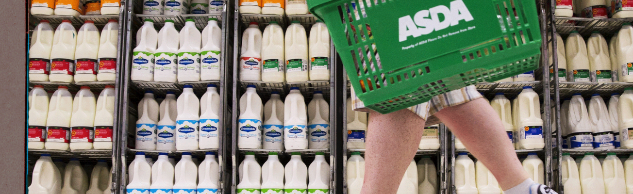A shopper carrying a supermarket basket.