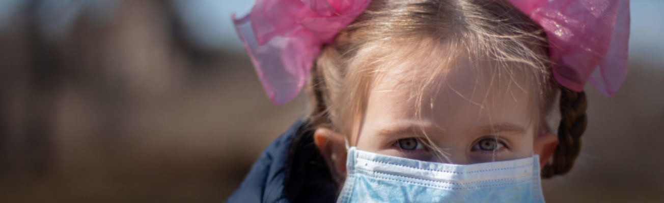 A child wearing a surgical mask