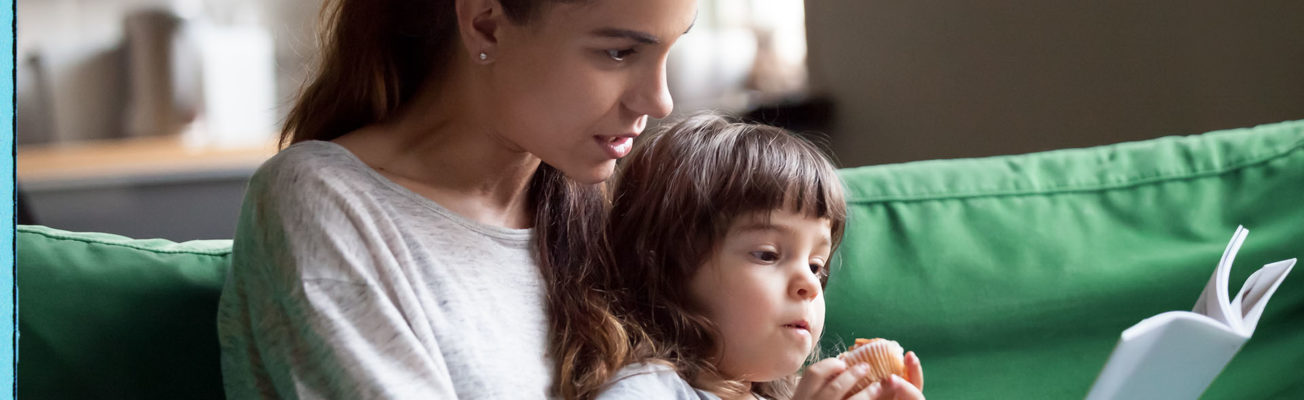 A woman reading to a child.