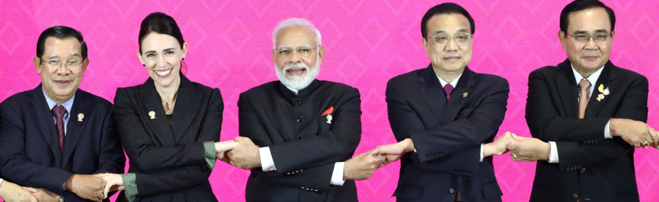 world leaders link arms at trade deal signing