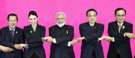 world leaders link arms at trade deal signing