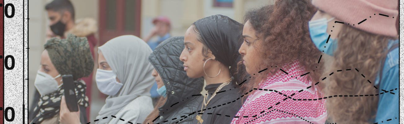 five women standing in a row wearing face masks