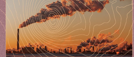 Streams of smoke coming out of an oil refinery at sunset