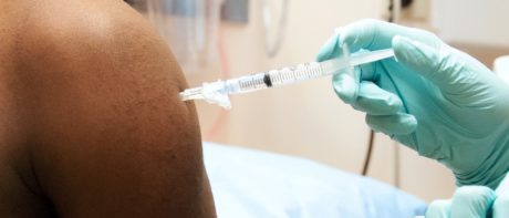 Person's arm being injected with a vaccine