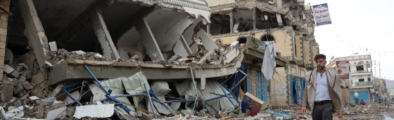 A man walks down a bombed-out street in Sa'ada, Yemen.