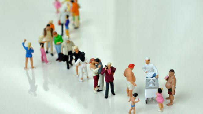 A queue of tiny figurines