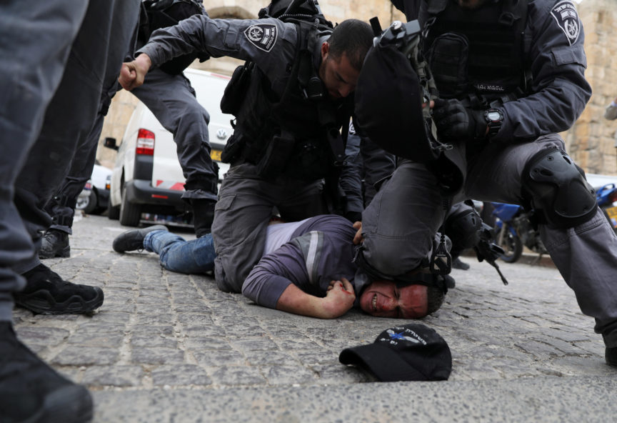 Police detain a Palestinian protester in Jersualem.