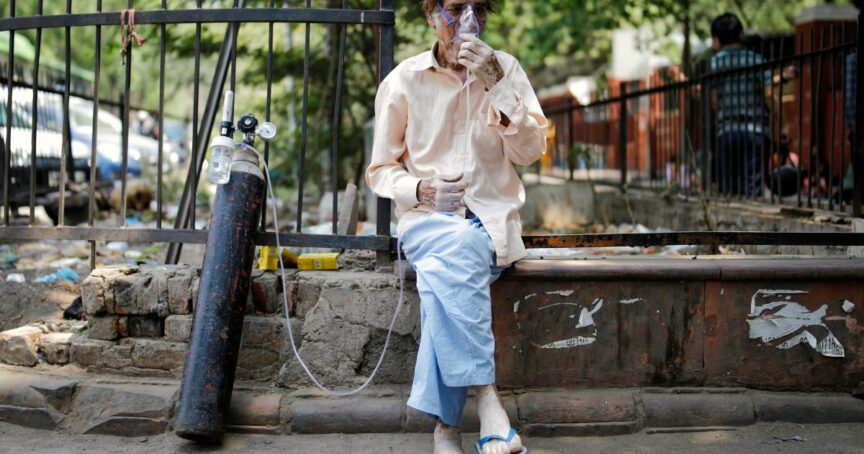 A patient sits outside Lok Nayak Jai Prakash Narayan Hospital (LNJP), one of India's largest Covid-19 facilities, New Delhi, April 2021. Ninian Reid/Flickr