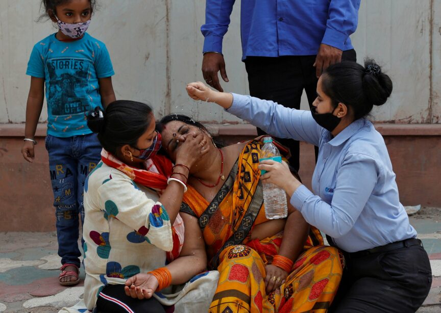 A woman is consoled outside a mortuary after her husband dies from Covid-19, New Delhi, April 2021. Ninian Reid/Flickr