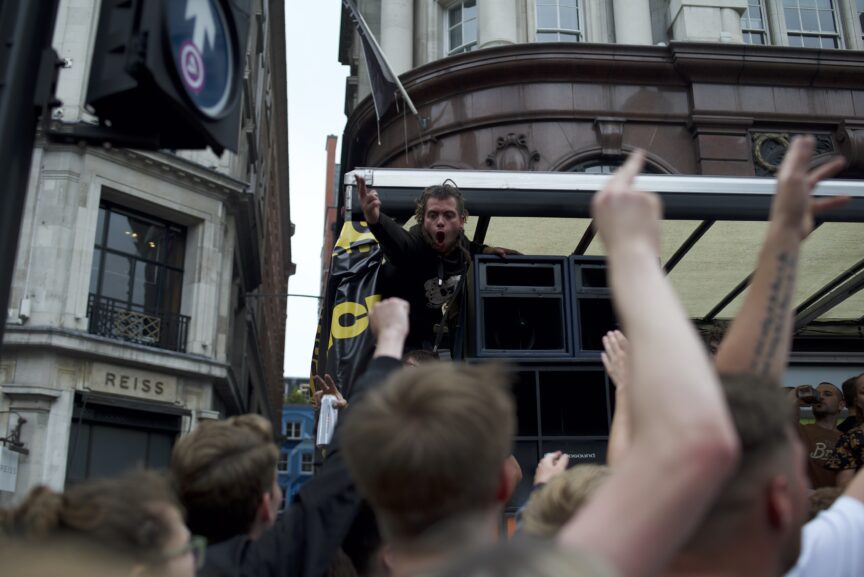 A crowd cheers at London's rave protest