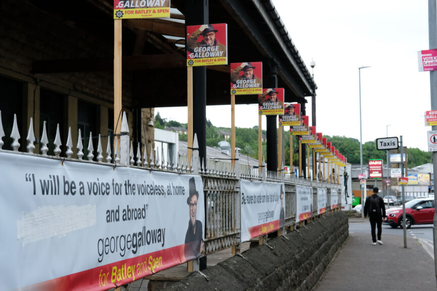 George Galloway posters at a train station