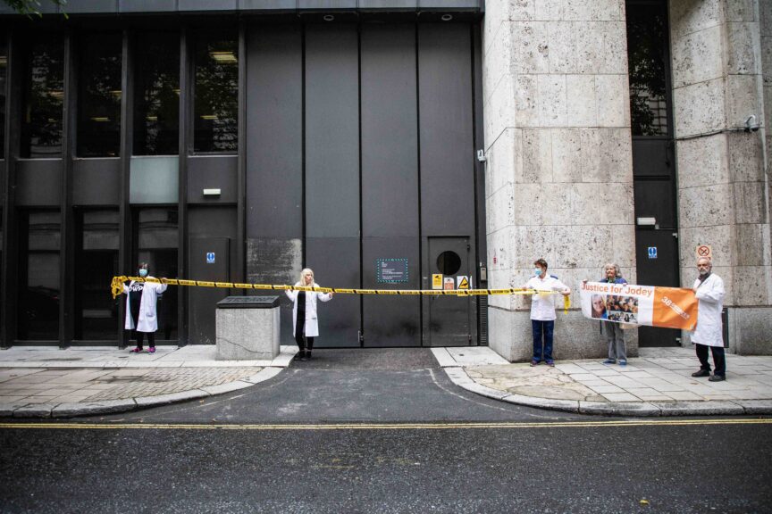 Activists "section" the DWP with yellow tape