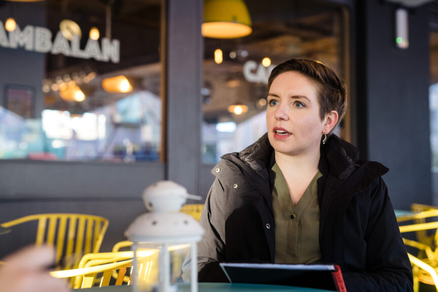 Green party co-leader Carla Denyer talking outside a cafe