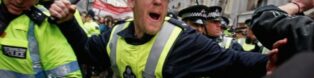 A police officer wielding a baton on Whitehall
