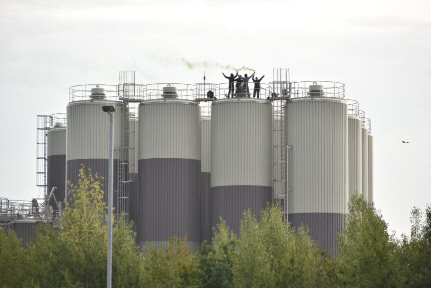 Activists stand on top of a milk factory