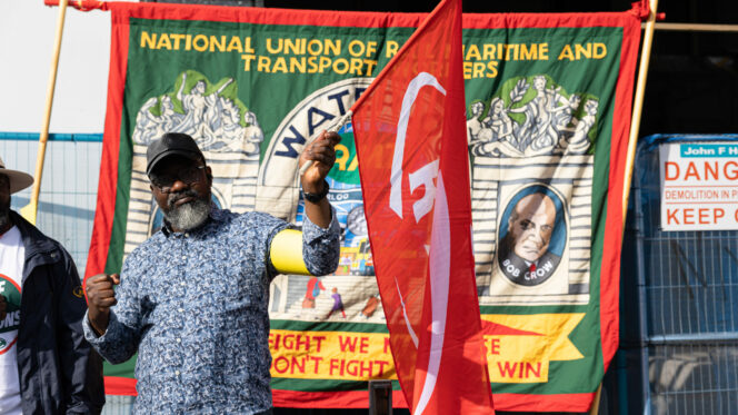 Image shows a member of the RMT Union is seen at the picket line at the Waterloo train station.