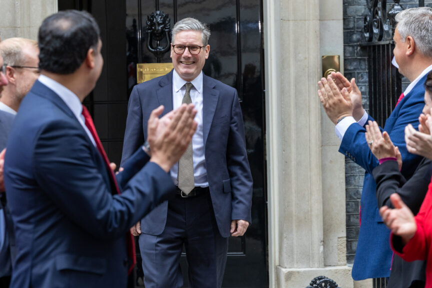 A group of politicians clap for Keir Starmer as he emerges from 10 Downing Street