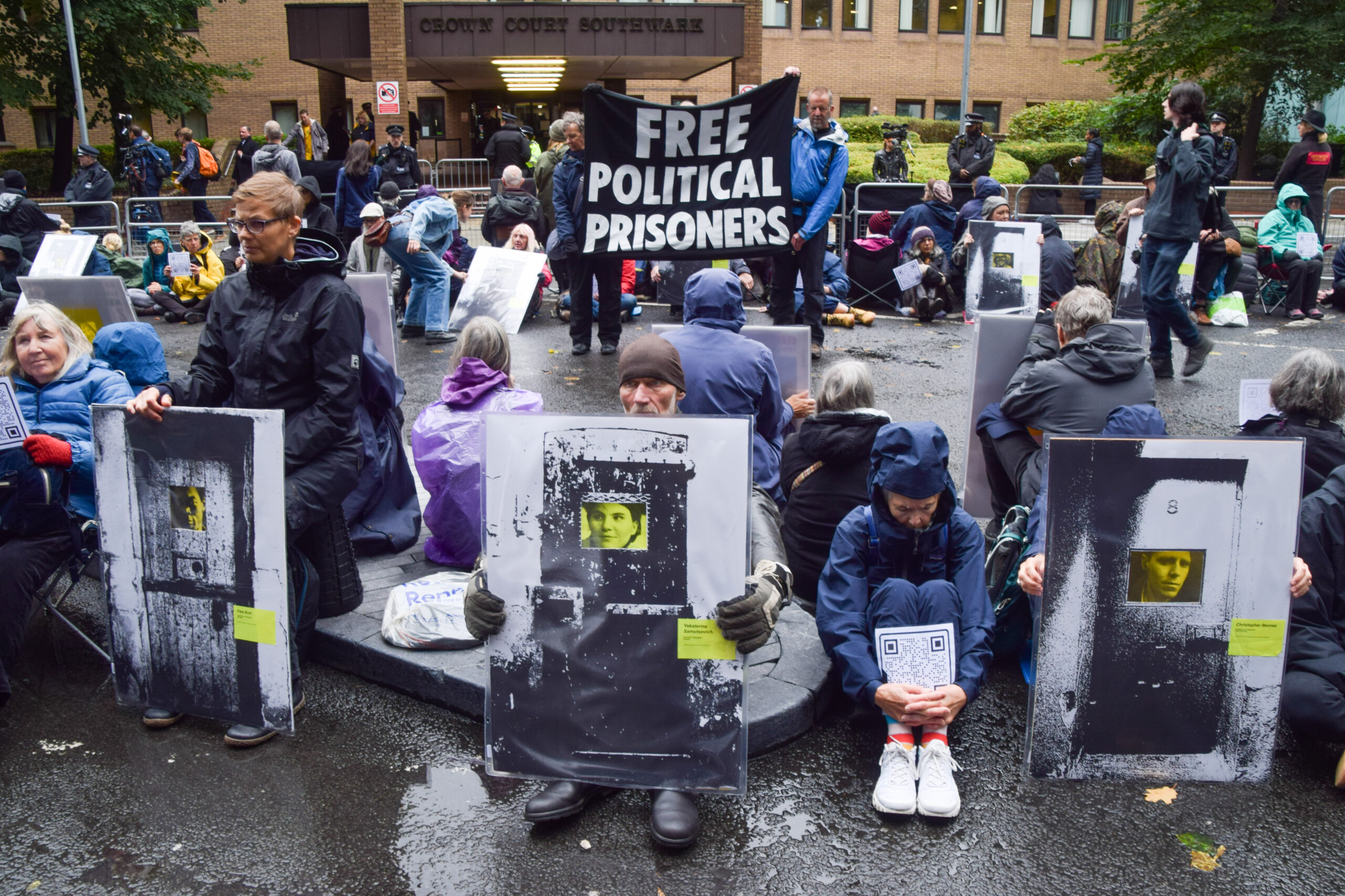 Protesters show support for political prisoners, including Just Stop Oil’s Chris Bennett (bottom right), September 2024. Vuk Valcic/Reuters