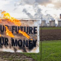 A banner is burned in protest outside Drax power station in North Yorkshire. Image: Axe Drax