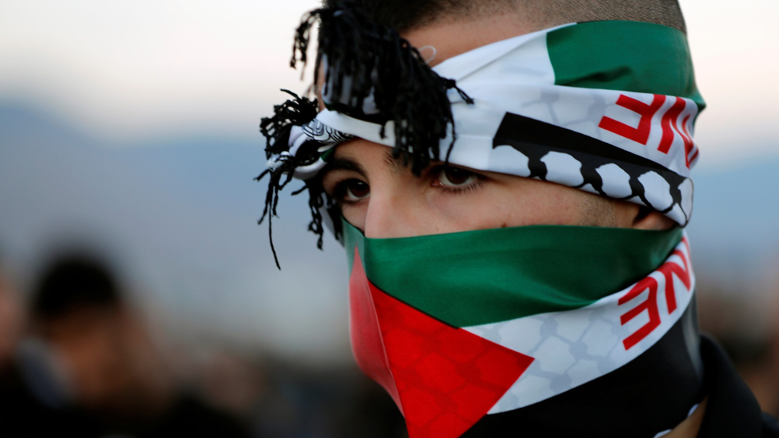 A youth with a scarf in Palestinian colours takes part in a protest in Majd al-Krum, northern Israel, October 2019. Ammar Awad/Reuters