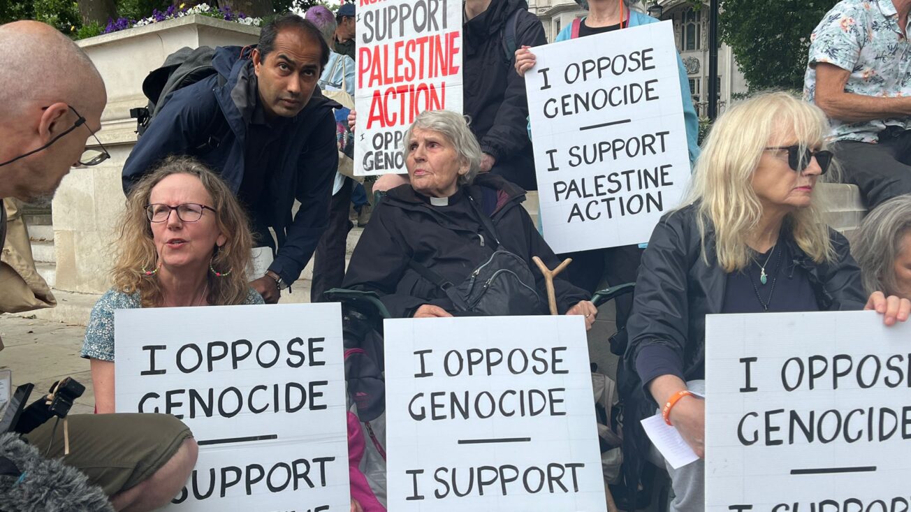 Protesters from defend juries with signs