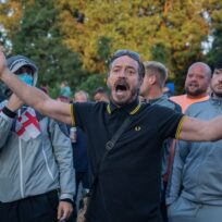 Anti-immigration protestors taunt asylum seekers inside Bell Hotel in Epping, behind a cordon of police. Lab Ky Mo/SOPA Images/Reuters Connect