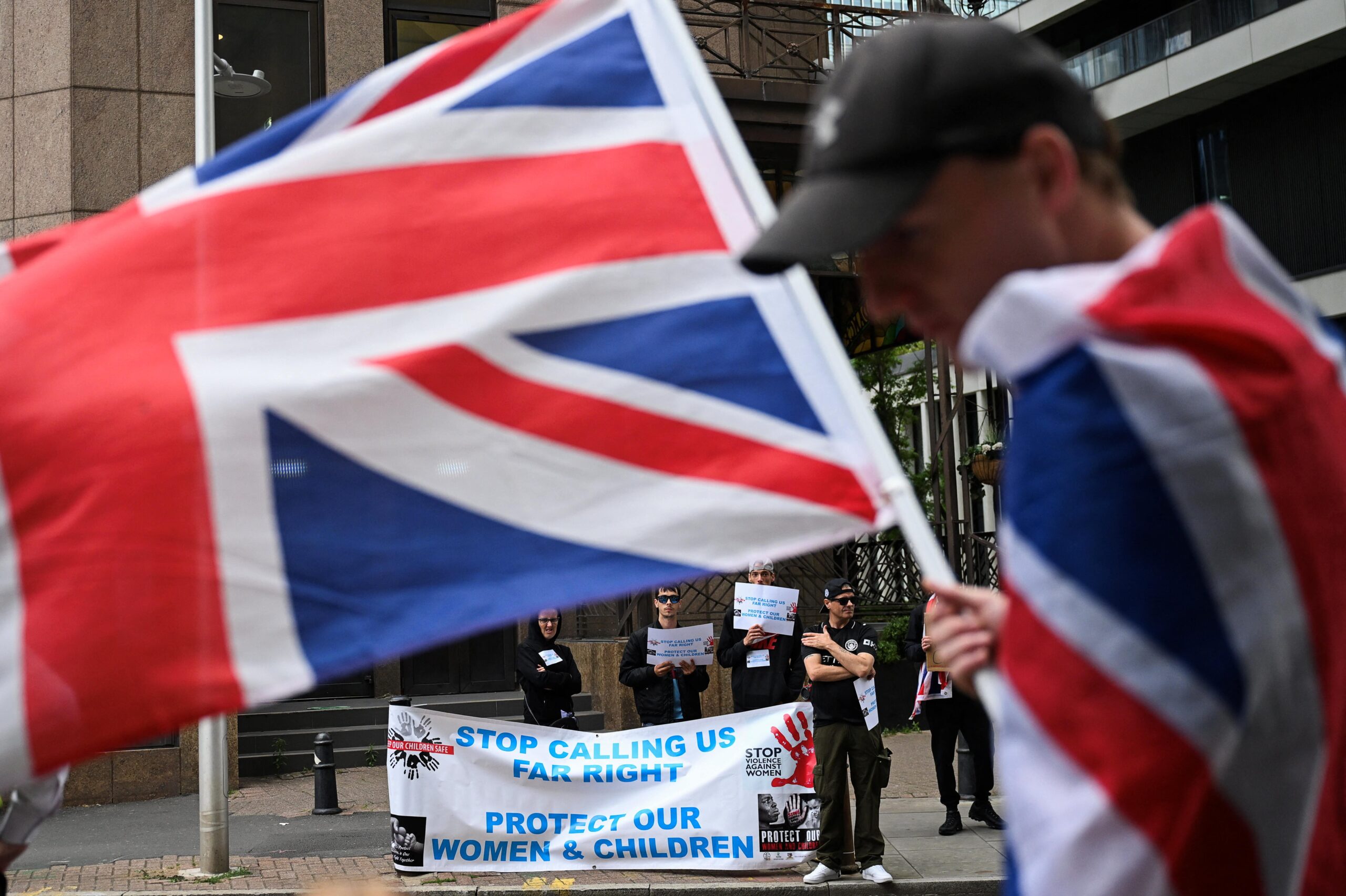 A demonstrator holds a Union Jack flag, during an anti-immigration protest outside the Britannia International Hotel in Canary Wharf, London, Britain, July 27, 2025. Photo: REUTERS/Jaimi Joy