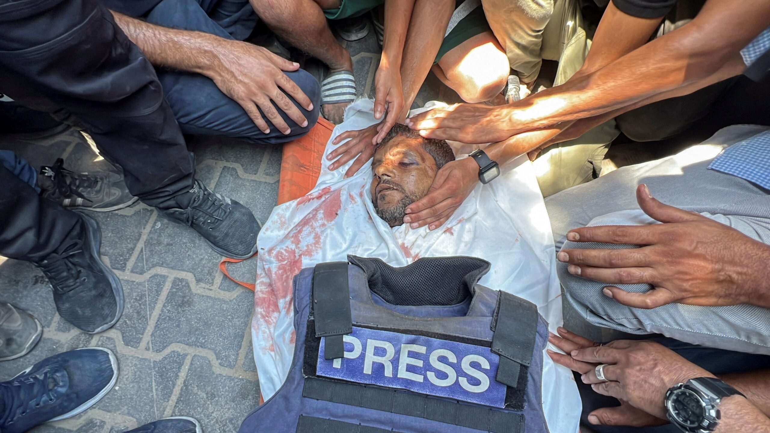 Mourners gather around the body of Palestinian cameraman Hussam al-Masri, a contractor for Reuters, after he was killed along with four other journalists in an Israeli ‘double tap’ attack on Nasser hospital in Khan Younis on 25 August 2025. Stringer/Reuters