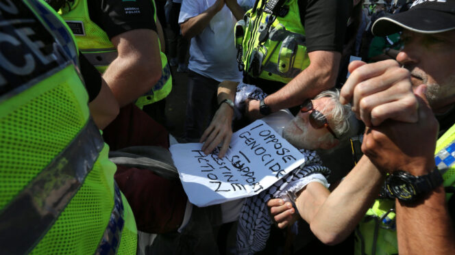 A protester arrested for holding a sign saying "I oppose genocide. I support Palestine Action" in Parliament Square in August. Photo: Martin Pope / SOPA Images