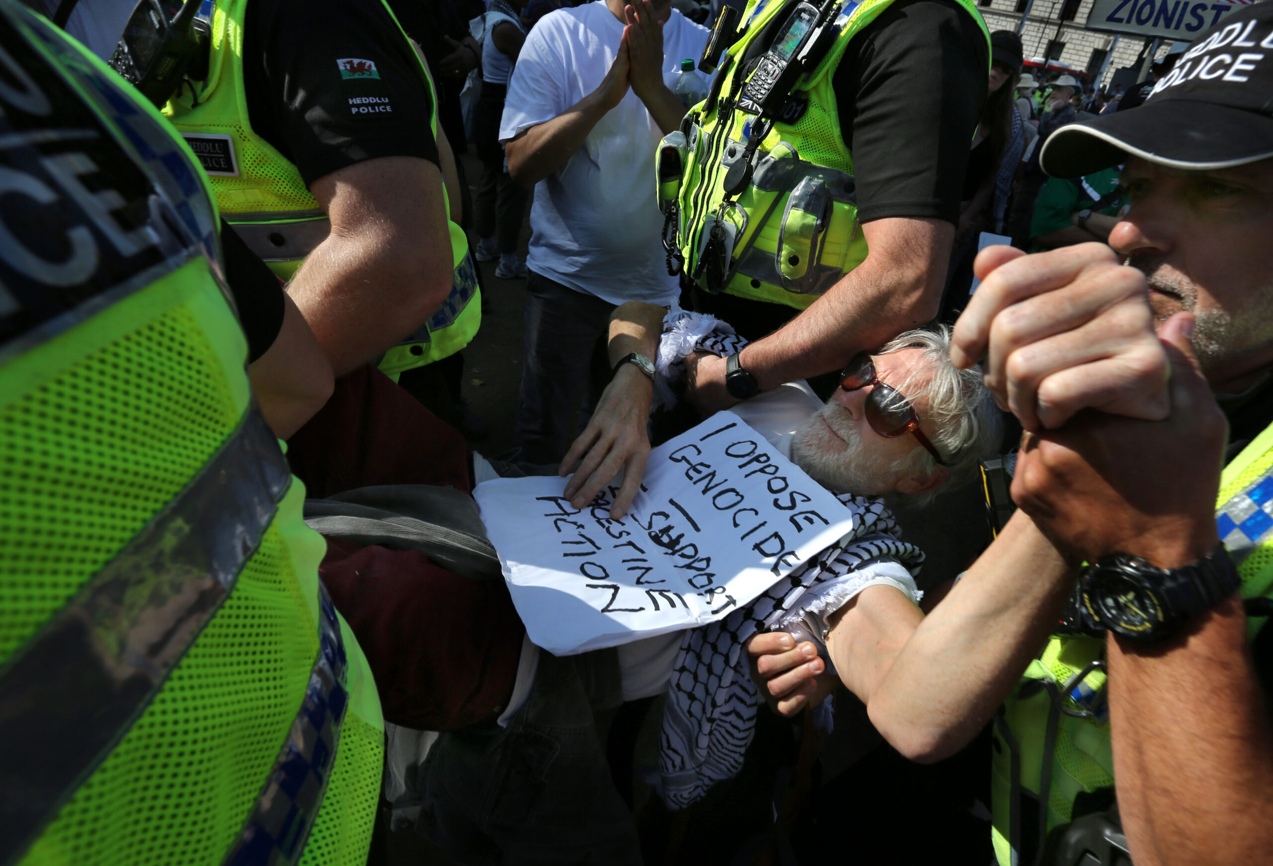 A protester arrested for holding a sign saying "I oppose genocide. I support Palestine Action" in Parliament Square in August. Photo: Martin Pope / SOPA Images