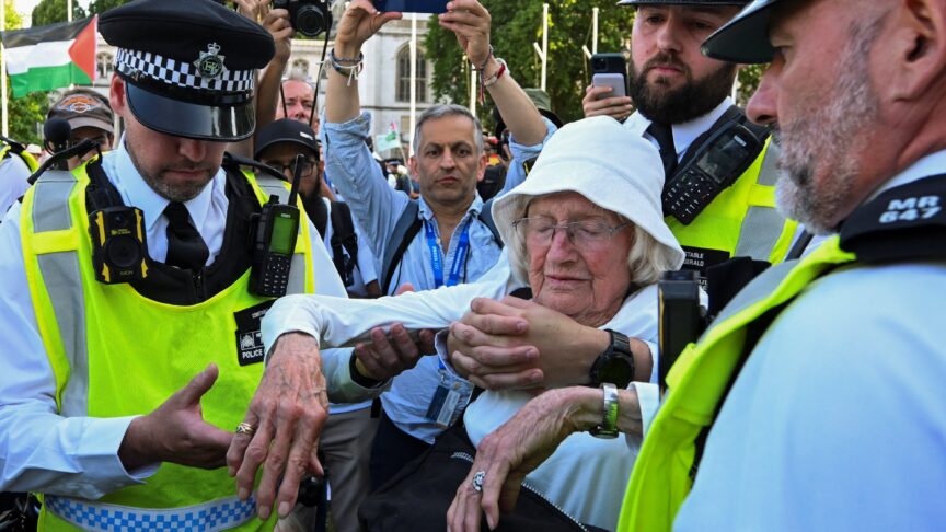 Police officers detain an 89-year-old protester, named La, during a rally organised by Defend Our Juries, challenging the British government's proscription of Palestine Action under anti-terrorism laws, in Parliament Square, London on 9 August 2025. Jaimi Joy/Reuters