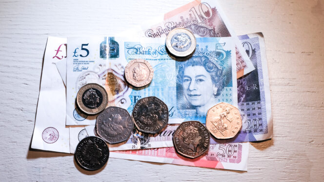 British Pound sterling bank notes and coins. Alberto Pezzali/NurPhoto/Reuters