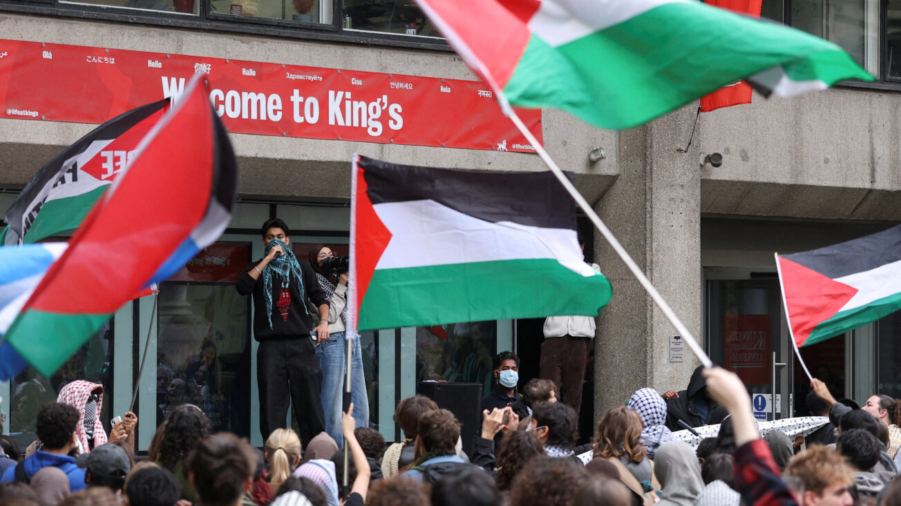 Protesters wave flags as students take part in an inter-university march in support of Palestinians, on the second anniversary of the deadly October 7, 2023 attack on Israel by Hamas from Gaza, at King's College London campus, Britain, October 7, 2025. REUTERS/Toby Melville