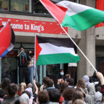 Protesters wave flags as students take part in an inter-university march in support of Palestinians, on the second anniversary of the deadly October 7, 2023 attack on Israel by Hamas from Gaza, at King's College London campus, Britain, October 7, 2025. REUTERS/Toby Melville