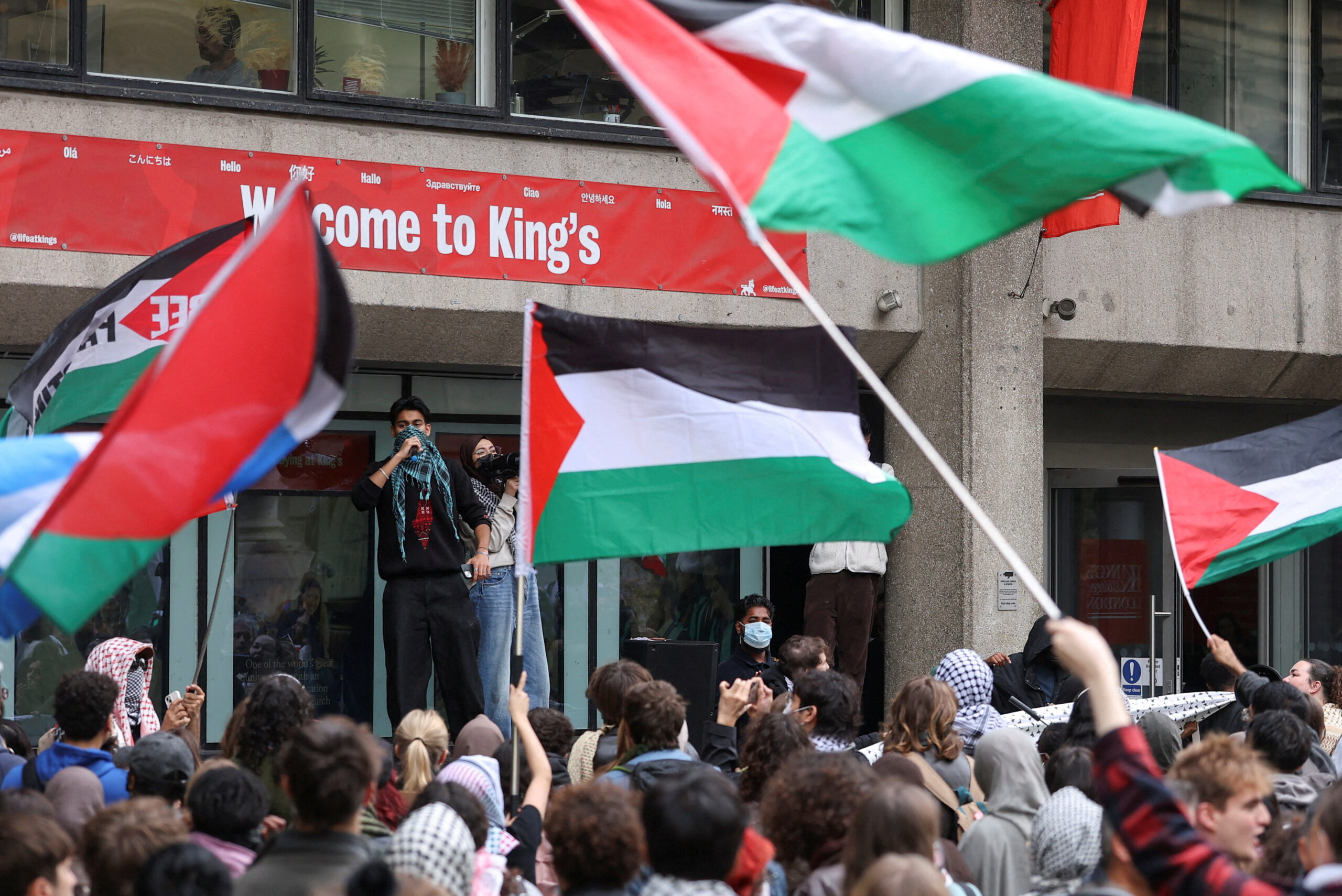 Protesters wave flags as students take part in an inter-university march in support of Palestinians, on the second anniversary of the deadly October 7, 2023 attack on Israel by Hamas from Gaza, at King's College London campus, Britain, October 7, 2025. REUTERS/Toby Melville