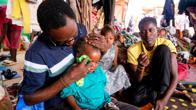 Al-Rasheed al-Tahir wipes the tears of his deceased sister's daughter after the family fled El Fasher city to a displacement cap in al-Dabba, Sudan, as the humanitarian situation deteriorates amid the ongoing conflict between the Rapid Support Forces (RSF) and the Sudanese army, 6 September 2025. REUTERS/El Tayeb Siddig