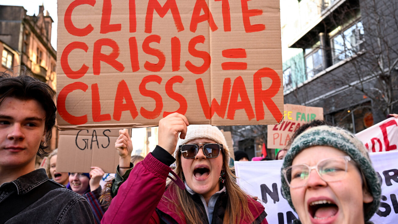 A person holds a placard during a march as part of nationwide protests calling for stronger global climate action during the ongoing UN climate change conference (COP30) in Brazil, in Glasgow, Scotland, 15 November 2025. REUTERS/Lesley Martin