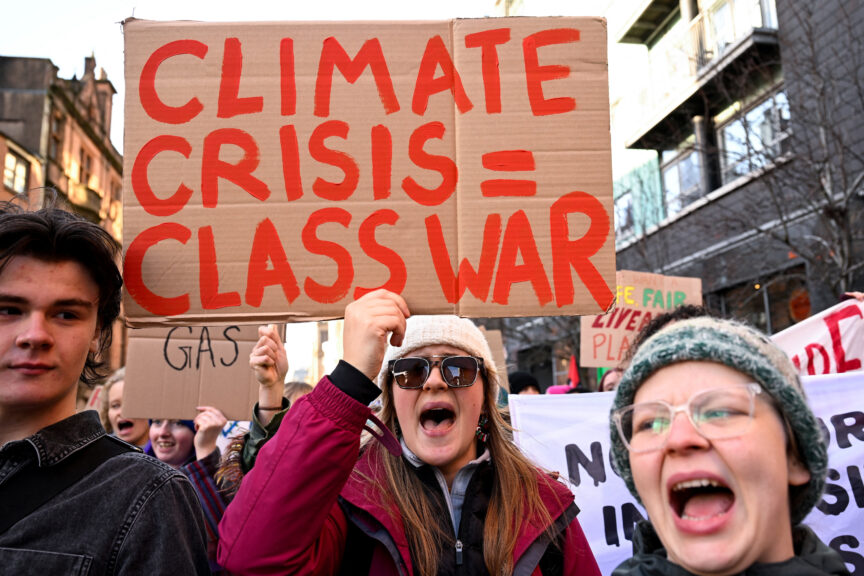 A person holds a placard during a march as part of nationwide protests calling for stronger global climate action during the ongoing UN climate change conference (COP30) in Brazil, in Glasgow, Scotland, 15 November 2025. REUTERS/Lesley Martin