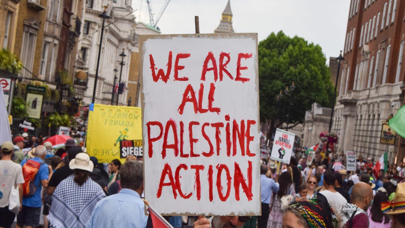 A protester holds a placard in support of the activist group Palestine Action during a demonstration in Whitehall, London, UK on 21 June 2025. SOPA Images Limited/Alamy Live News