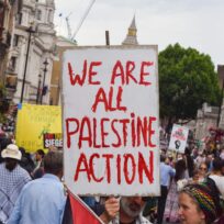 A protester holds a placard in support of the activist group Palestine Action during a demonstration in Whitehall, London, UK on 21 June 2025. SOPA Images Limited/Alamy Live News