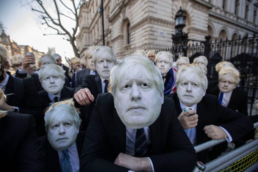 Flash-mob of ‘partygate’ anti-Boris Johnson protesters wearing floppy blond wigs and Boris Johnson masks and suits gathered outside Downing Street after the UK prime minister was put under investigation for holding a drinks party at No 10 on various occasions, breaking the Covid lockdown restrictions, 14 January 2022. Jeff Gilbert/Alamy Live News