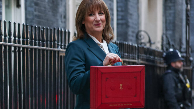 woman with brown hair poses with red box