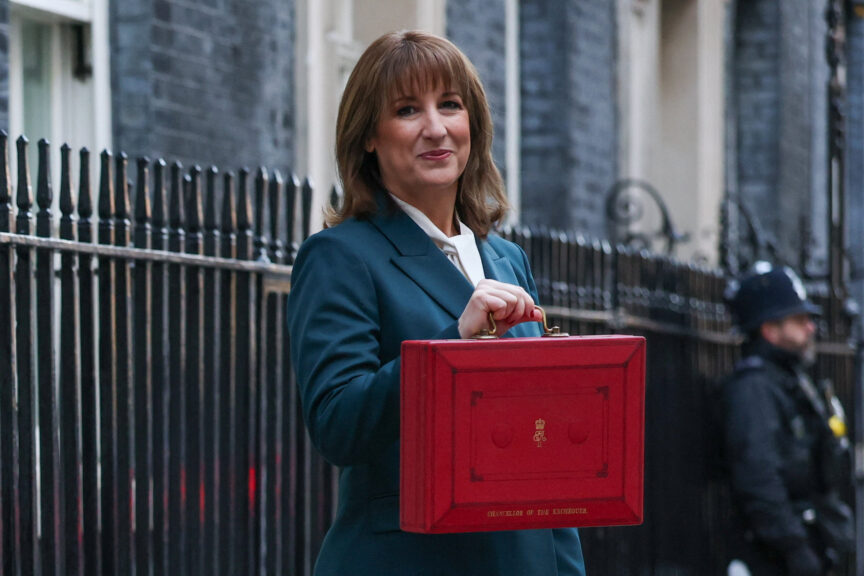 woman with brown hair poses with red box
