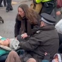 Dr Olivia Brandon being dragged by her hood at a protest for the hunger strikers outside HMP Bronzefield on Wednesday 17 December. Image: X/@revoltinghippie