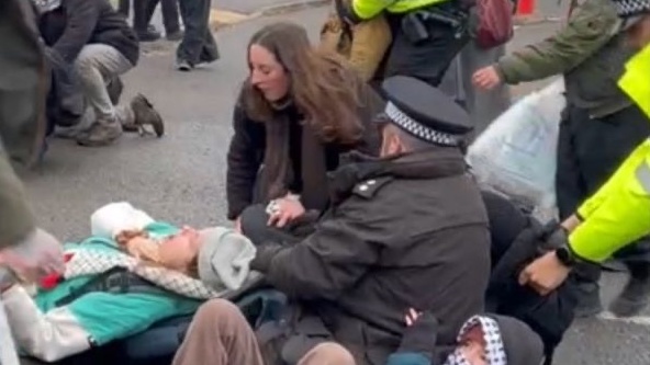 Dr Olivia Brandon being dragged by her hood at a protest for the hunger strikers outside HMP Bronzefield on Wednesday 17 December. Image: X/@revoltinghippie