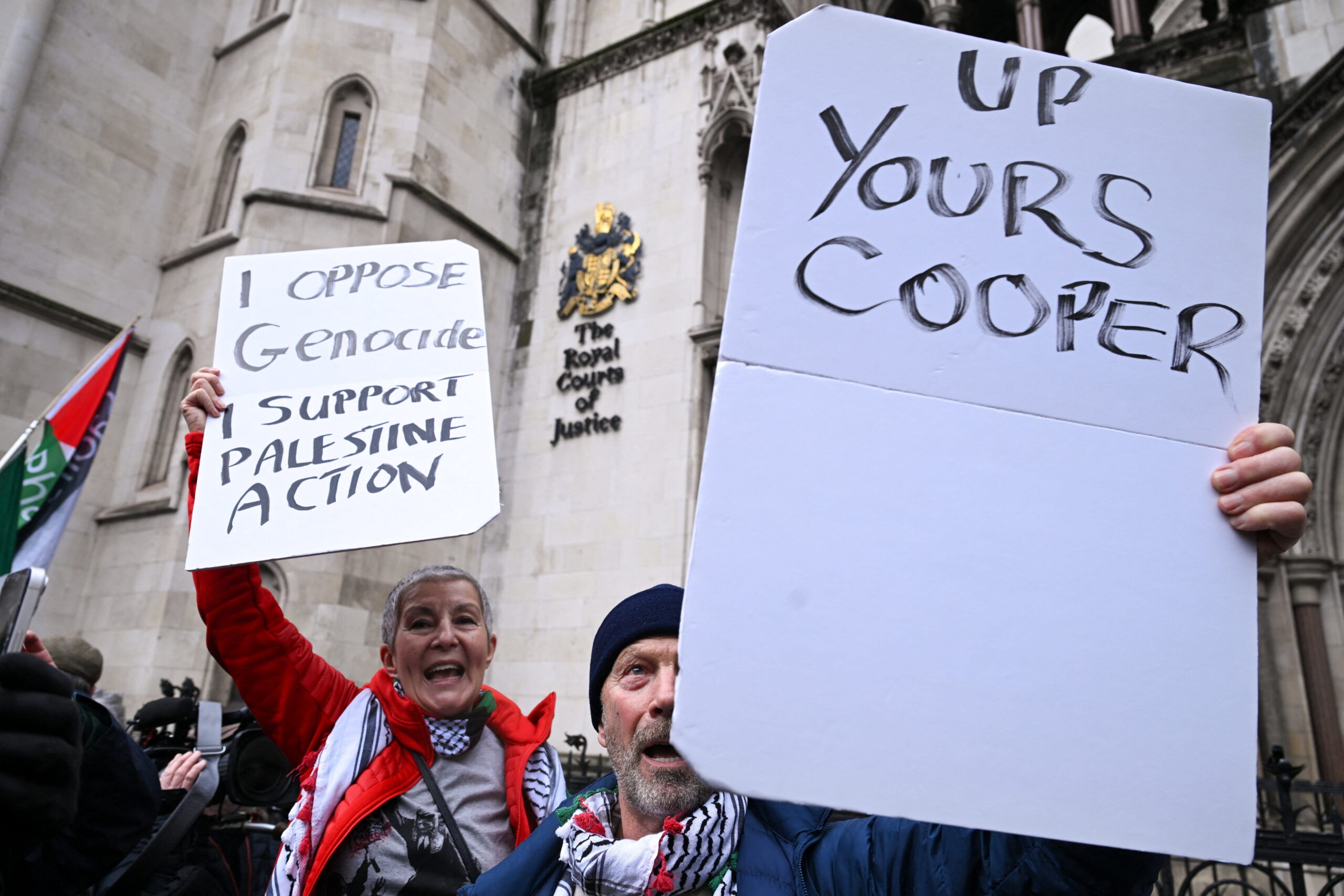 Protesters hold signs outside the High Court, after judges ruled the British government’s decision to designate pro‑Palestinian group Palestine Action as a terrorist organisation unlawful, in London, Britain, 13 February 2026. Reuters/Jaimi Joy