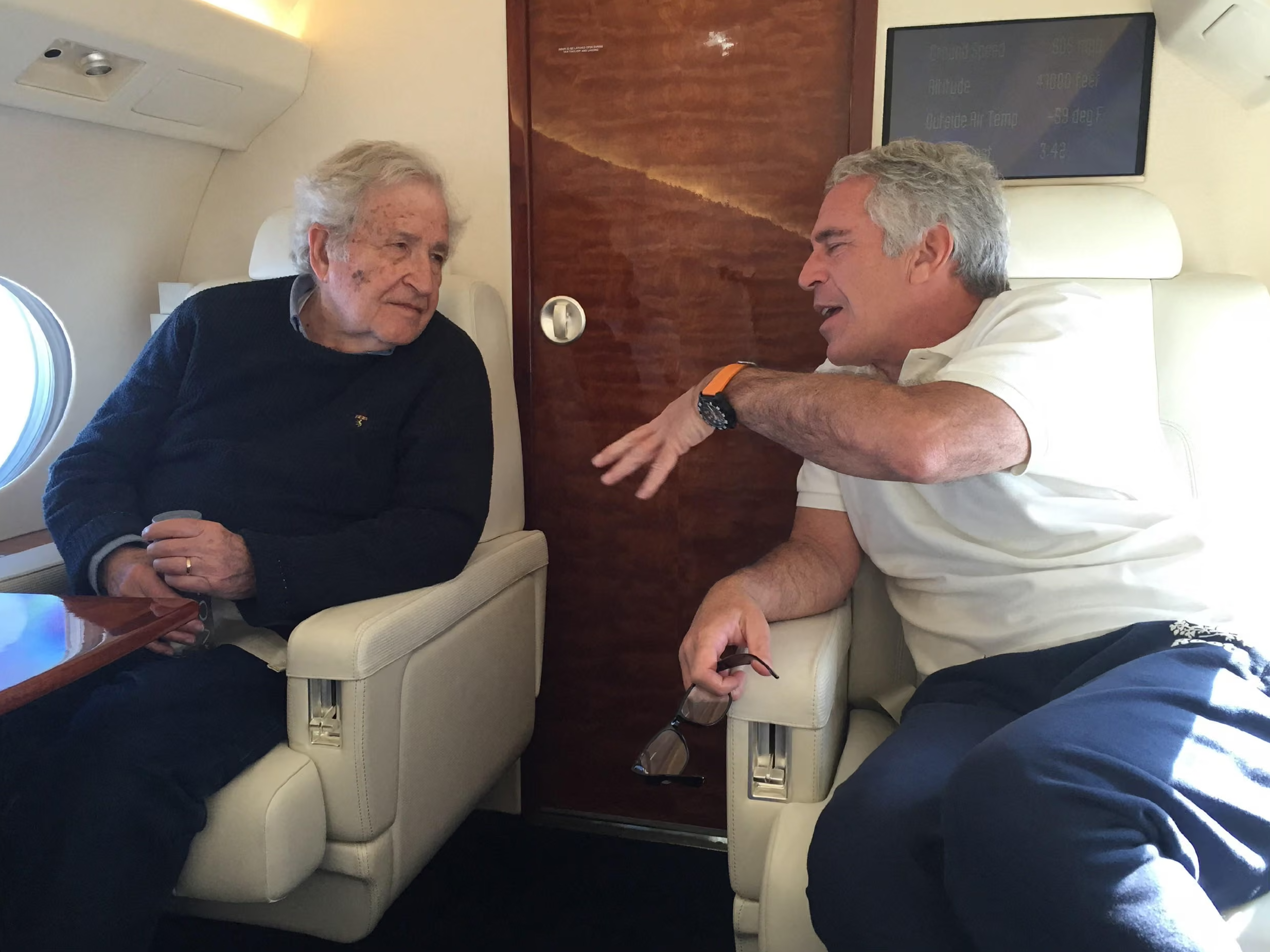 Two grey-haired men talk